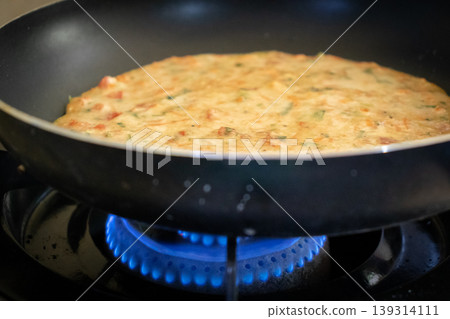easy Egg-Oats omelette cooking on a pan easy Egg-Oats omelette cooking on a pan 139314111