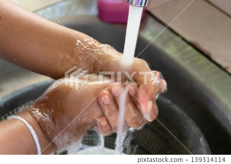applying soap and washing with clean running water 139314114