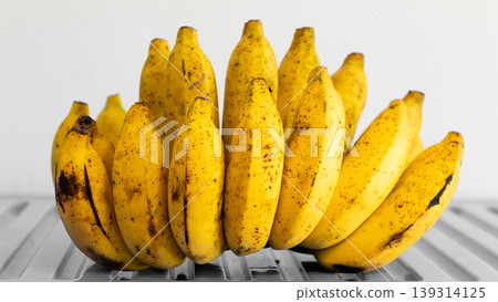 Hand of Cavendish bananas in white background Hand of Cavendish bananas in white background 139314125