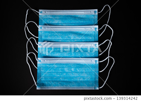 Four Medical Face Masks lined up in black background Four Medical Face Masks lined up in black background 139314242