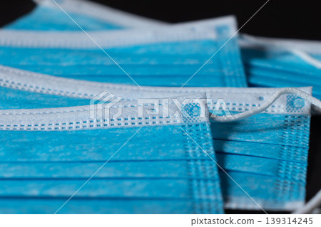 Surgical masks close up dark background Surgical masks close up dark background 139314245