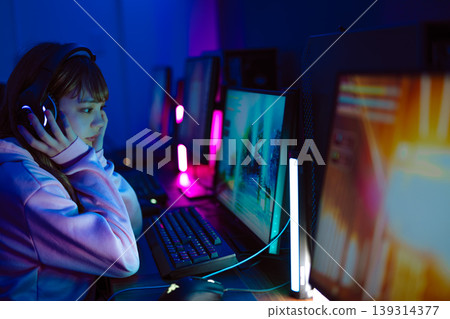 A woman playing games on a gaming PC A woman playing games on a gaming PC 139314377