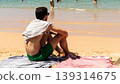 Young male sunbathing and enjoying the view in the picturesque beach 139314675