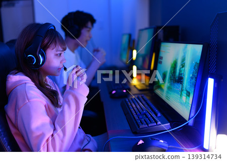 Men and women playing games on gaming PCs 139314734