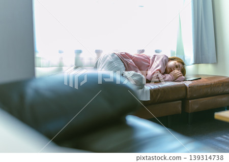 A woman sleeping on the sofa A woman sleeping on the sofa 139314738