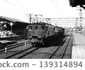 A freight train pulled by an ED16 locomotive awaiting departure. 139314894