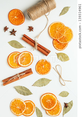 Dried oranges and cinnamon on a white background Dried oranges and cinnamon on a white background 139314961