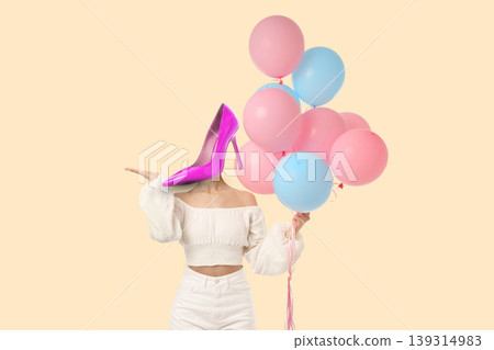 Woman with heel instead head holding balloons 139314983