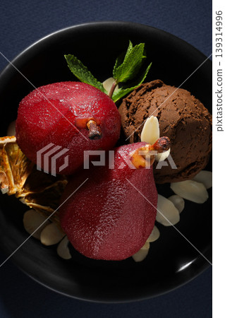 Bowl contains red pears, chocolate ice cream, and nuts 139314996