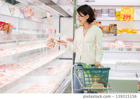 Female shopper buying meat at the supermarket Female shopper buying meat at the supermarket 139315156