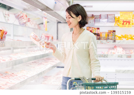 Female shopper buying meat at the supermarket Female shopper buying meat at the supermarket 139315159