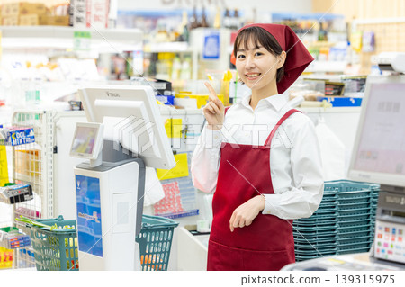 A woman working at super cash register A woman working at super cash register 139315975