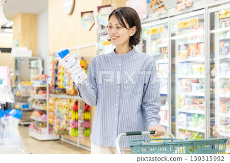 A woman shopping at a supermarket 139315992