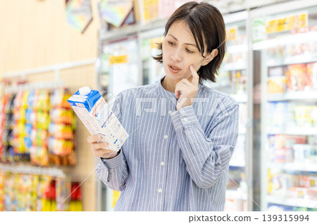 A woman shopping at a supermarket 139315994