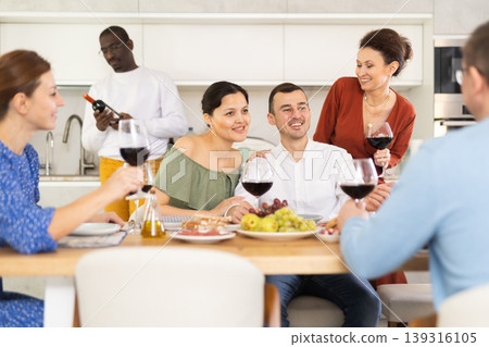 Multiethnic women and men friends chatting and drinking Multiethnic women and men friends chatting and drinking 139316105