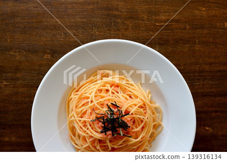 Tarako pasta with a table background viewed from directly above. Tarako pasta with a table background viewed from directly above. 139316134