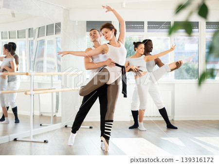 Young man and adult woman rehearsing pair ballet 139316172
