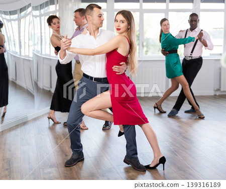 Woman dances incendiary tango with man partner during choreography lesson 139316189