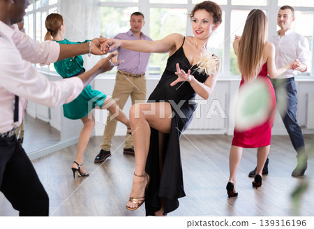 Man and woman practicing swing dance in dancing studio 139316196