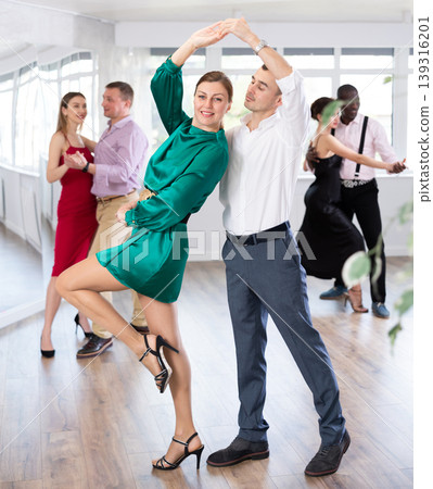 Man and woman dancing waltz in couple during lesson at studio Man and woman dancing waltz in couple during lesson at studio 139316201