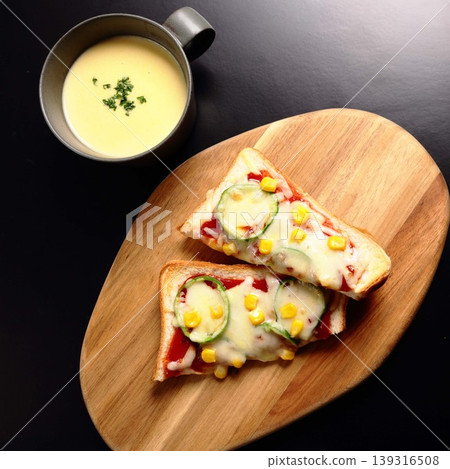 A pizza toast with melted cheese looks delicious as a late-night snack. A pizza toast with melted cheese looks delicious as a late-night snack. 139316508