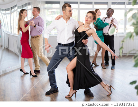 Man and woman dancing waltz in couple during lesson at studio Man and woman dancing waltz in couple during lesson at studio 139317351