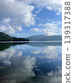 The tranquil surface of Lake Shikaribetsu, a water mirror as if time has stopped, is adorned with a landscape of clouds blending seamlessly into it. 139317388