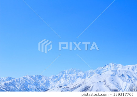 View of the Northern Alps from the summit of Mt. Iwatake in Hakuba in March; Mountains of Shinshu; Snow-capped Northern Alps View of the Northern Alps from the summit of Mt. Iwatake in Hakuba in March; Mountains of Shinshu; Snow-capped Northern Alps 139317705