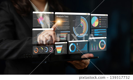 Business Professional Interacting with Digital Data Dashboard Displaying Charts, Graphs, and Analysis Metrics in a Modern Corporate Setting Ledger Business Professional Interacting with Digital Data Dashboard Displaying Charts, Graphs, and Analysis Metrics in a Modern Corporate Setting Ledger 139317732