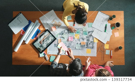 Time lapse of skilled engineer working together to design building. Symposium. Time lapse of skilled engineer working together to design building. Symposium. 139317734
