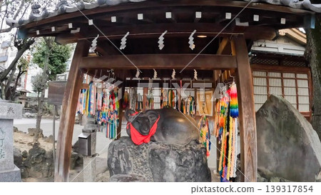 The statue of a cow and colorful paper cranes at Ushijima Shrine in Tokyo. The statue of a cow and colorful paper cranes at Ushijima Shrine in Tokyo. 139317854