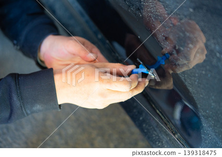 Removing dents on the car. PDR technology. Car body repair without painting. Removing dents on the car. PDR technology. Car body repair without painting. 139318475