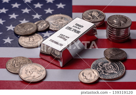 A silver bar, white metal against a backdrop of USA flag, as a concept. A silver bar A silver bar, white metal against a backdrop of USA flag, as a concept. A silver bar 139319120
