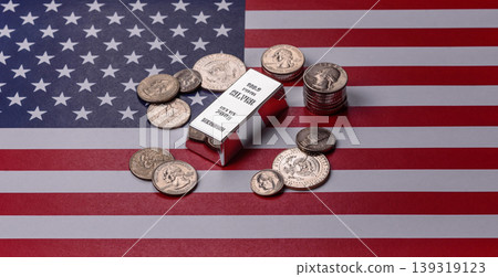 A silver bar, white metal against a backdrop of USA flag, as a concept. A silver bar A silver bar, white metal against a backdrop of USA flag, as a concept. A silver bar 139319123