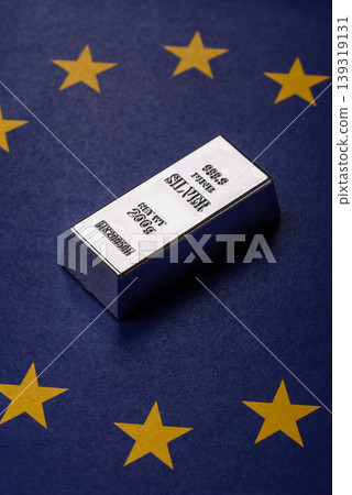 A silver bar, white metal against a backdrop of EU flag, as a concept. A silver bar A silver bar, white metal against a backdrop of EU flag, as a concept. A silver bar 139319131