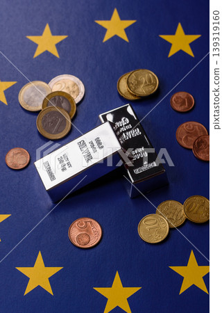 A silver bar, white metal against a backdrop of EU flag, as a concept. A silver bar A silver bar, white metal against a backdrop of EU flag, as a concept. A silver bar 139319160