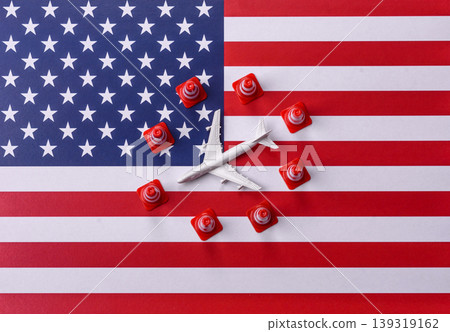 A mock up of airplane with no fly signs on a US flag as a concept for a flight ban 139319162