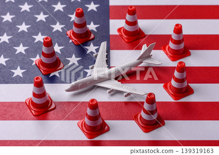 A mock up of airplane with no fly signs on a US flag as a concept for a flight ban A mock up of airplane with no fly signs on a US flag as a concept for a flight ban 139319163