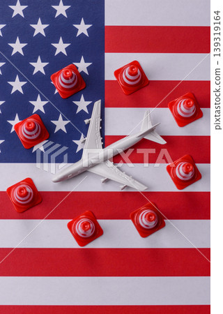 A mock up of airplane with no fly signs on a US flag as a concept for a flight ban A mock up of airplane with no fly signs on a US flag as a concept for a flight ban 139319164