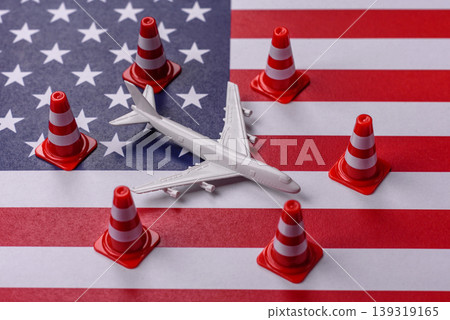 A mock up of airplane with no fly signs on a US flag as a concept for a flight ban A mock up of airplane with no fly signs on a US flag as a concept for a flight ban 139319165