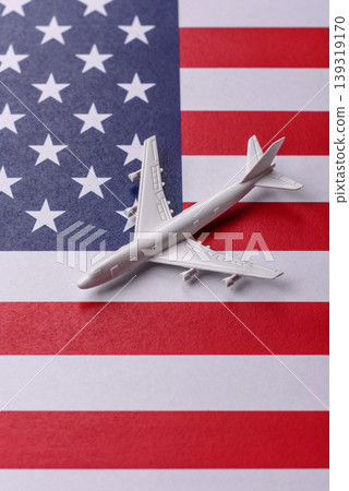 An airplane on the US flag as a conceptual backdrop for flights and travel. An airplane on the flag An airplane on the US flag as a conceptual backdrop for flights and travel. An airplane on the flag 139319170