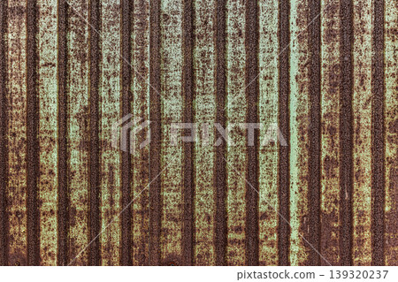 Vintage rusty corrugated metal wall texture background with weathered industrial iron sheet and green paint for architectural design Vintage rusty corrugated metal wall texture background with weathered industrial iron sheet and green paint for architectural design 139320237