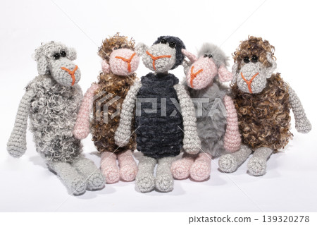 Crocheted sheeps toy on a white background Crocheted sheeps toy on a white background 139320278