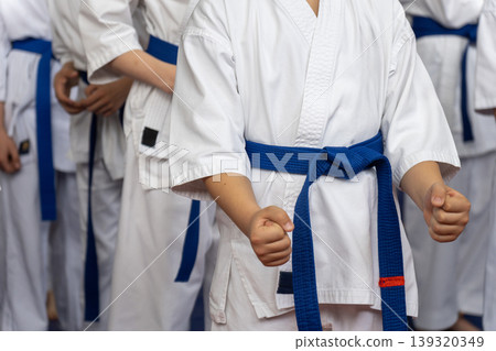Close-up of young karate students in white gi Close-up of young karate students in white gi 139320349
