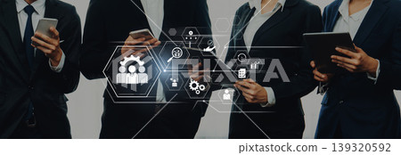 Business Professionals Using Technology for Team Collaboration and Strategy Development, Focus on Communication Icons and Digital Interaction Tools Trope Business Professionals Using Technology for Team Collaboration and Strategy Development, Focus on Communication Icons and Digital Interaction Tools Trope 139320592