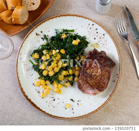 Baked or fried veal in plate with cheakpea Baked or fried veal in plate with cheakpea 139320751