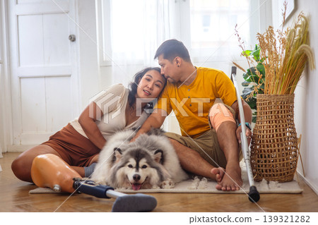 Cozy indoor scene with a couple and their fluffy dog Cozy indoor scene with a couple and their fluffy dog 139321282
