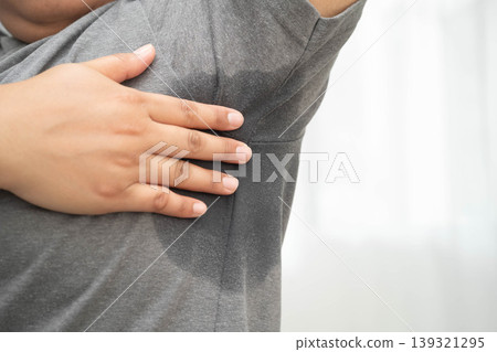 Sweaty underarms, Asian woman with sweat on clothes under armpit. 139321295