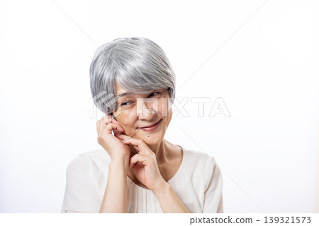 一位白髮蒼蒼的老婦人露出夢幻般的微笑。 139321573