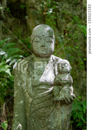 Jizo Bosatsu statue holding baby at Mitaki-Dera in Hiroshima Jizo Bosatsu statue holding baby at Mitaki-Dera in Hiroshima 139321583